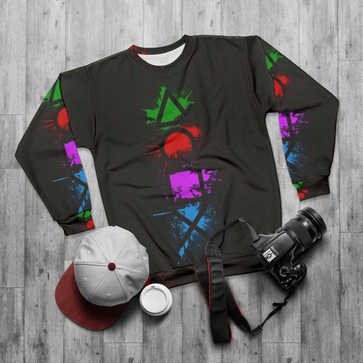 Playstation controller buttons splatter design on a cozy sweatshirt - flat lay