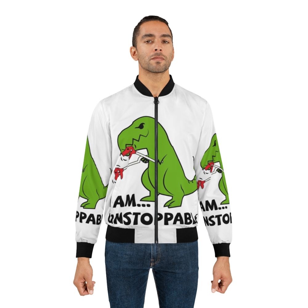 A green and red bomber jacket with a T-Rex print and the text "I am unstoppable" on it. - Lifestyle