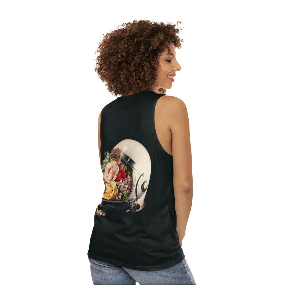 An astronaut in a space suit surrounded by flowers and stars on a cosmic, surreal tank top - women back