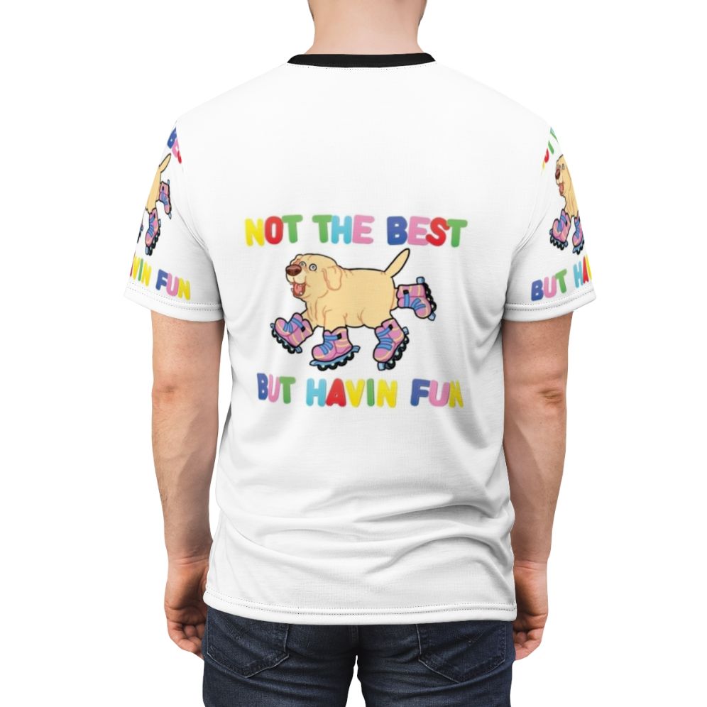 An AOP (all-over print) t-shirt featuring a playful dog on rollerskates or rollerblades, with the text "Not the best, but having fun". - men back