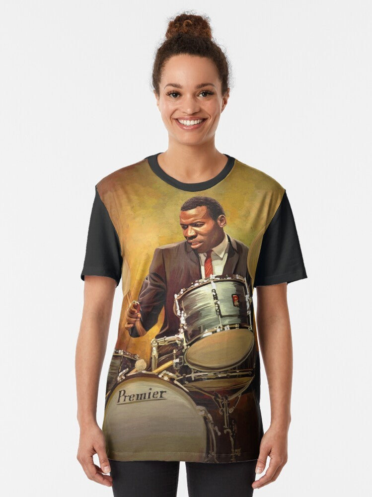 Graphic t-shirt featuring Elvin Jones, the iconic jazz drummer known for his work with John Coltrane and bebop/hard bop styles. - Women