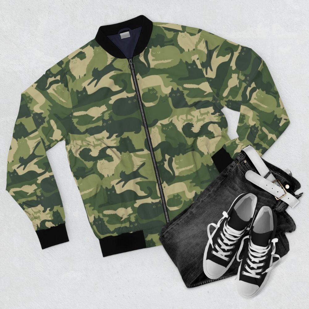 Green camouflage bomber jacket with cat silhouettes pattern - Flat lay