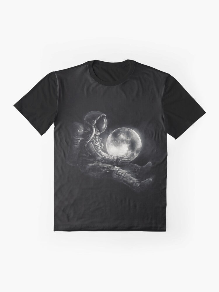 A black and white graphic t-shirt featuring a surreal, cosmic design with an astronaut or spaceman playing on the moon. - Flat lay