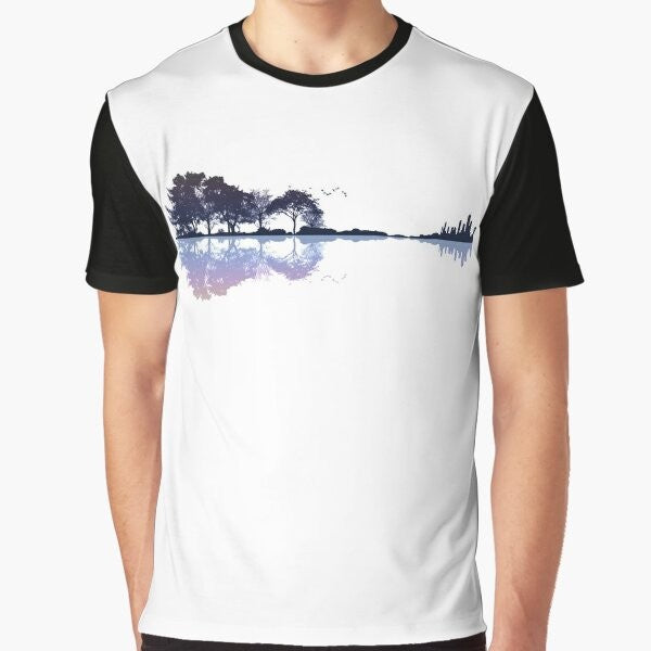 A nature-inspired graphic t-shirt featuring a guitar silhouette against a landscape with trees, water, and a cityscape.