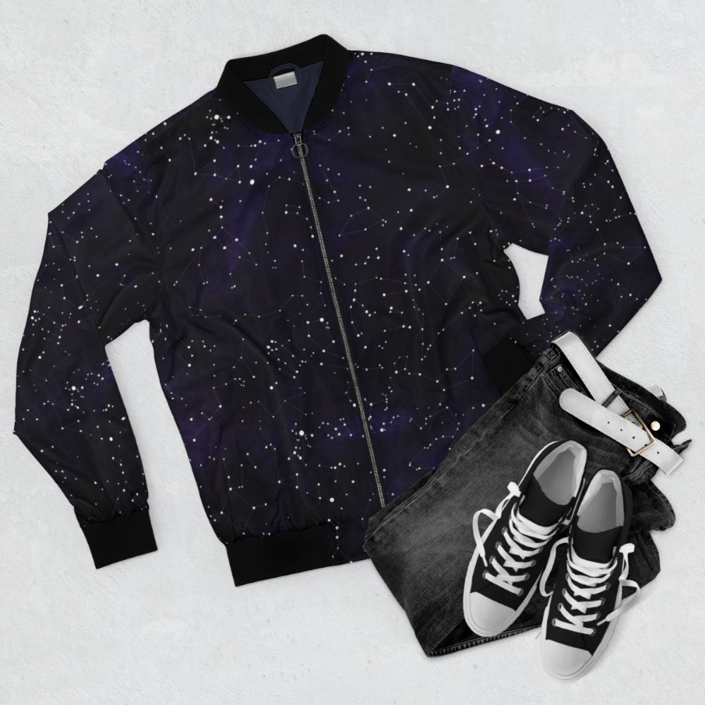 Bomber jacket featuring a design of constellations and stars in the night sky - Flat lay