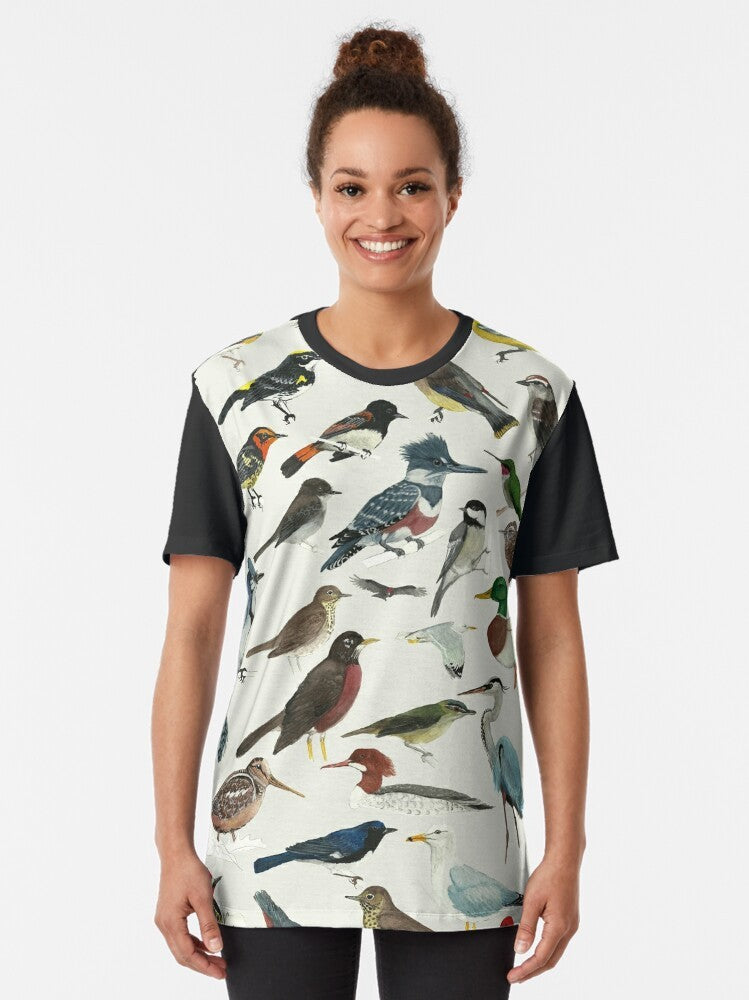 A stylish graphic t-shirt featuring a variety of birds, including the black-throated blue, blackburnian, and ruby-throated hummingbird, for bird lovers and nature enthusiasts. - Women