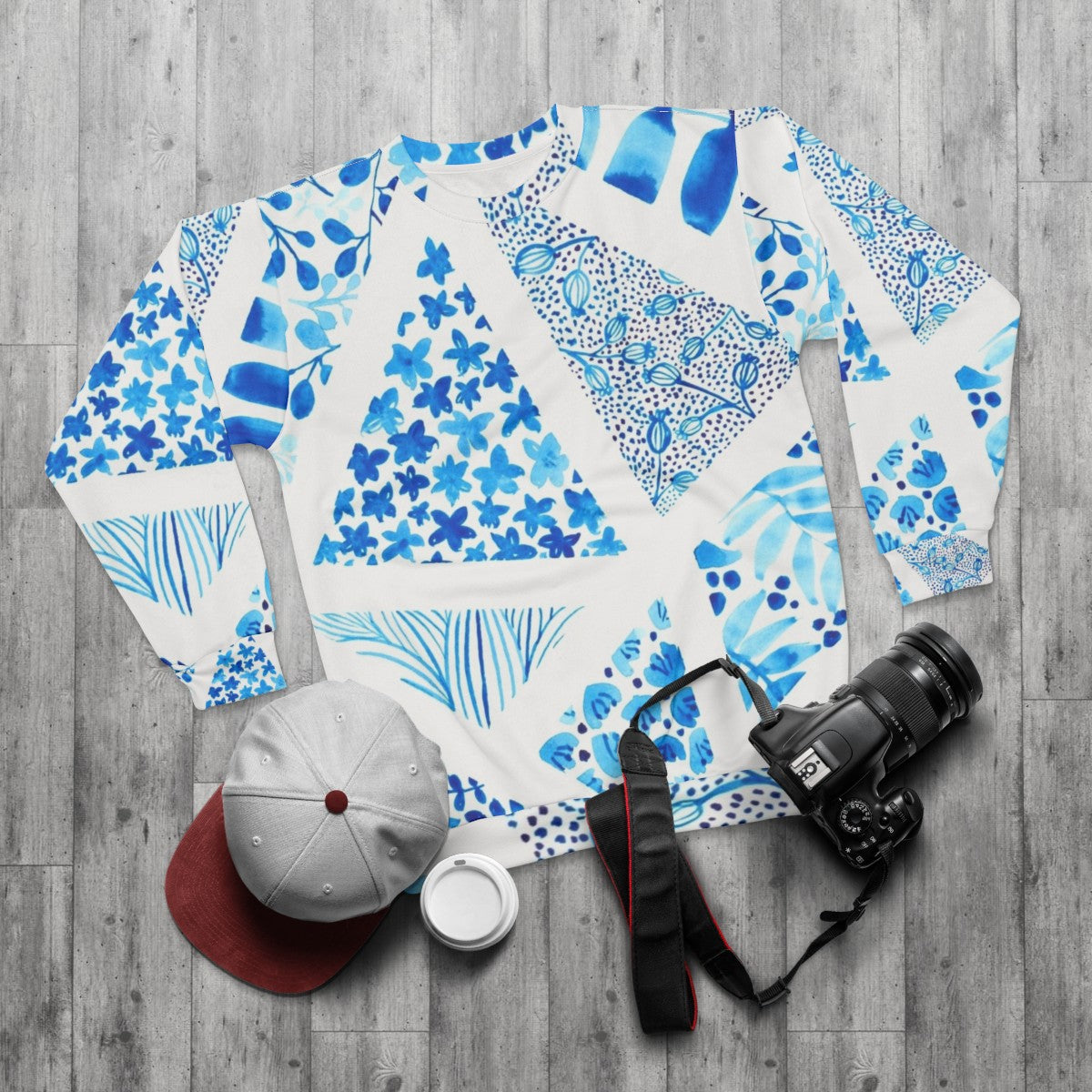 Blue abstract pattern sweatshirt with nature-inspired design - flat lay