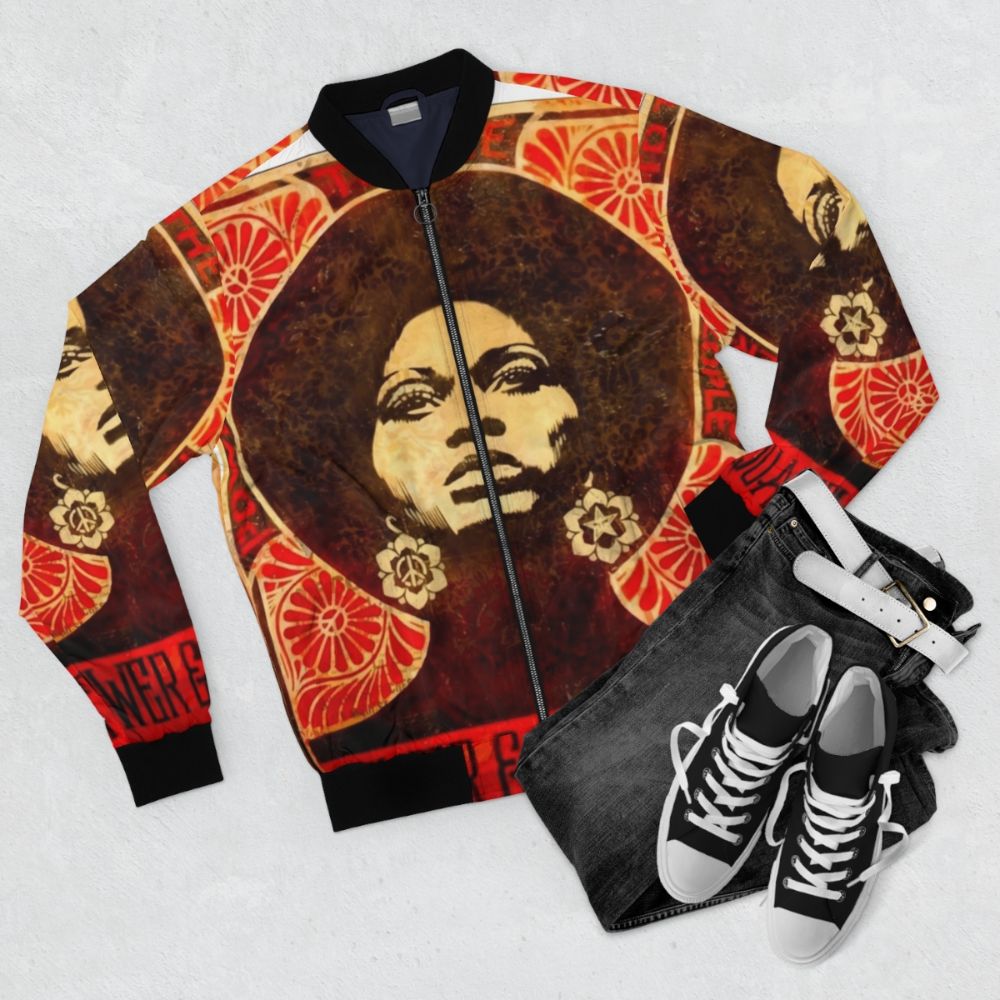 Black and white image of Angela Davis with afro and power fist, 1971 bomber jacket - Flat lay