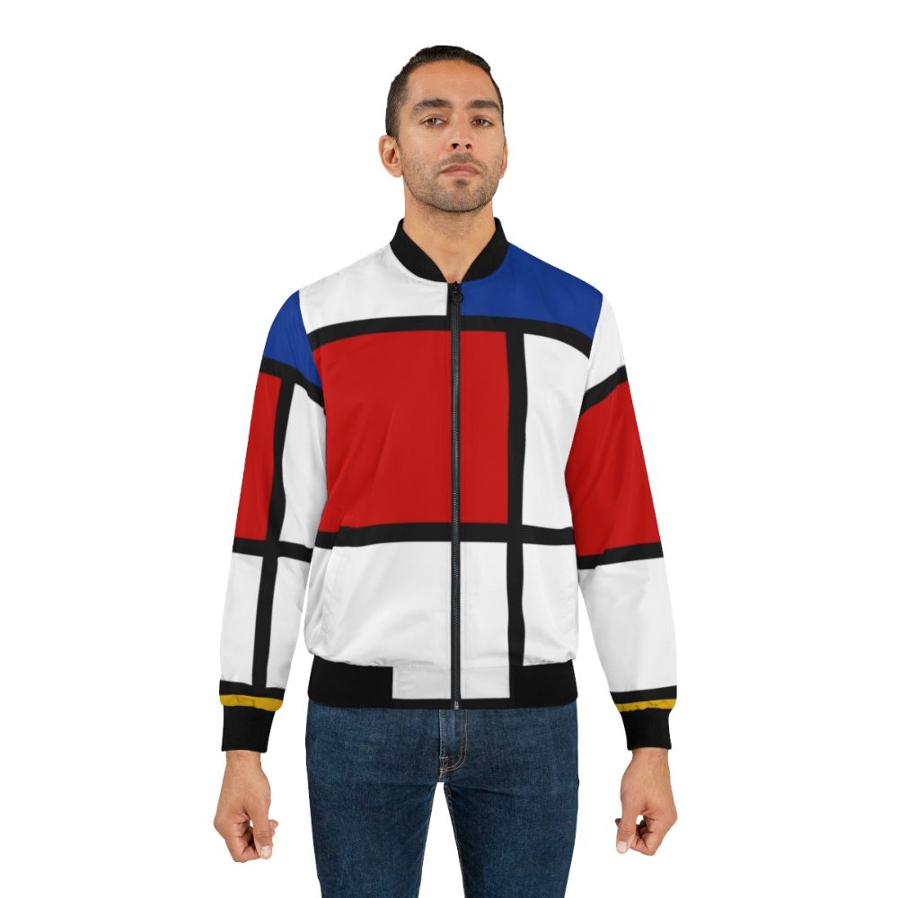 A men's bomber jacket with a Mondrian-inspired abstract geometric pattern in primary colors of red, yellow, and blue. - Lifestyle