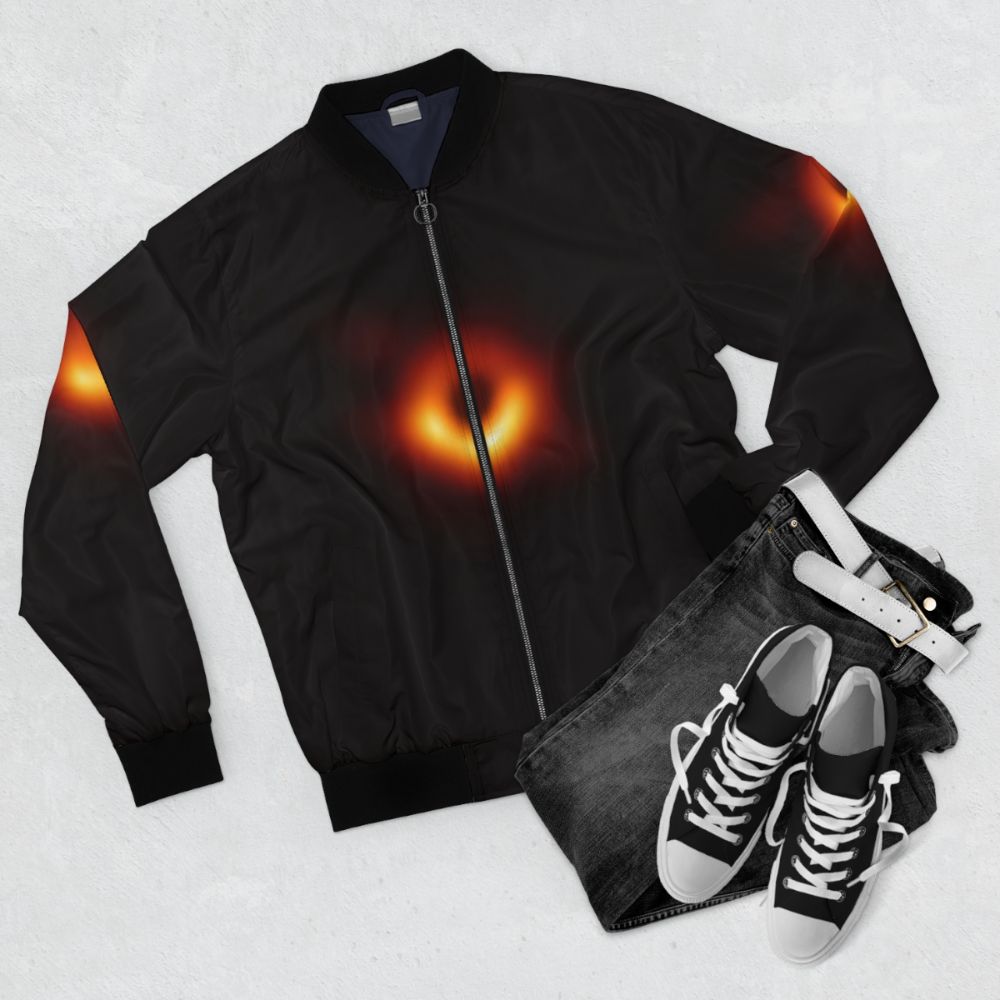 Black hole bomber jacket featuring event horizon and cosmic design - Flat lay