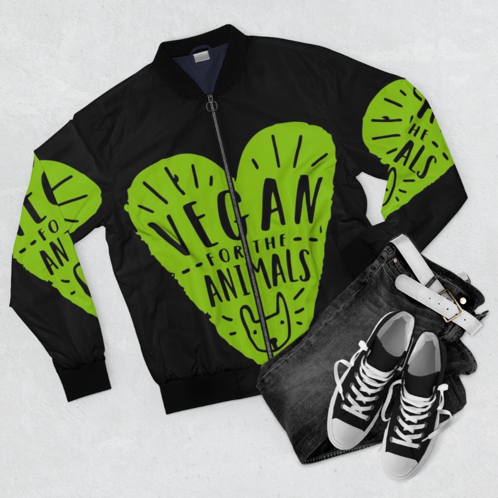 Vegan bomber jacket with "Vegan for the Animals" design, showcasing compassion for animals and a cruelty-free lifestyle. - Flat lay