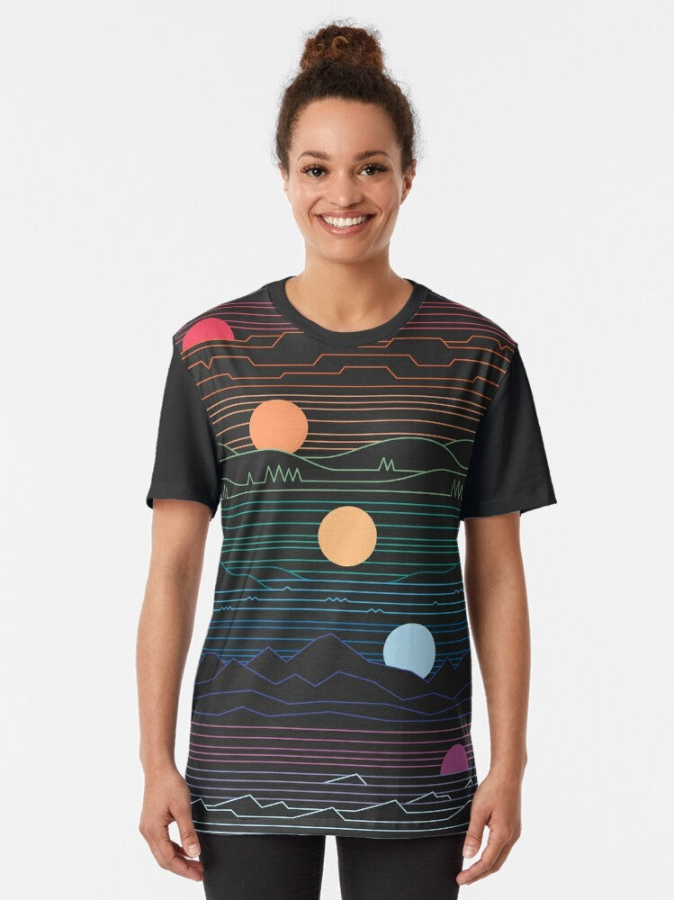 Minimalist graphic t-shirt design featuring a sun and landscape elements in pastel colors, evoking a vintage, vaporwave-inspired aesthetic. - Women