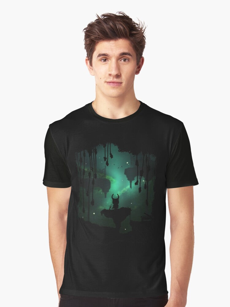 A graphic t-shirt featuring the Greenpath environment from the Hollow Knight game, with leafy elements, birds, and a peaceful nature theme. - Men