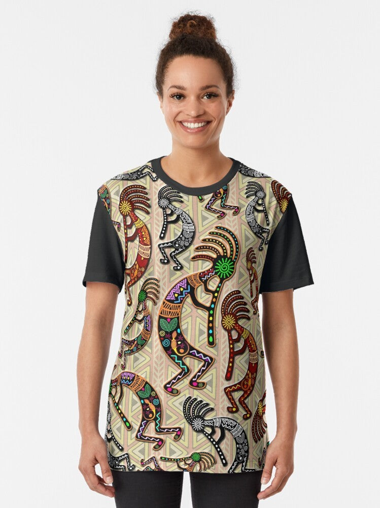 Kokopelli, a mythological trickster god from Native American culture, depicted in a tribal pattern design on a graphic t-shirt. - Women