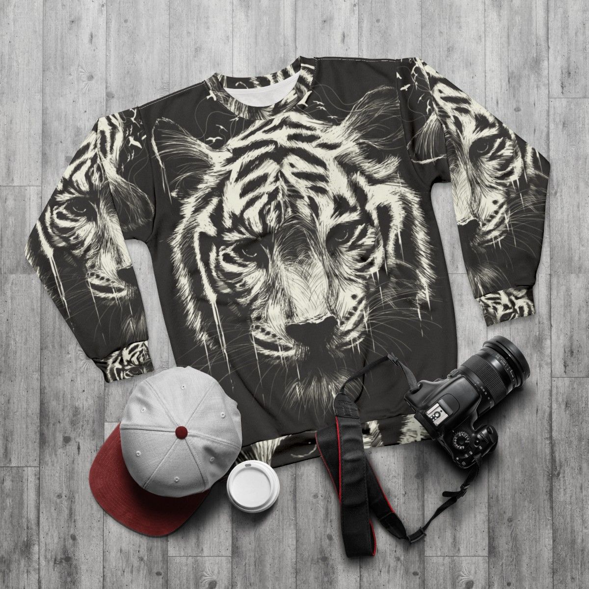 Interconnected sweatshirt with surreal, photorealistic tiger and bird graphics - flat lay