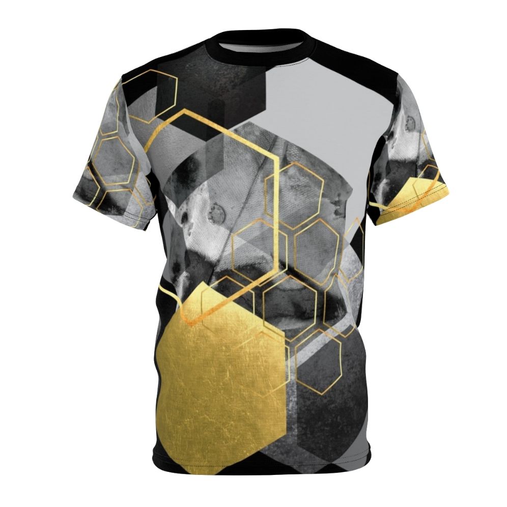 Closeup of a modern, minimalist t-shirt featuring a geometric hexagon collage design in black, white, and gold tones.