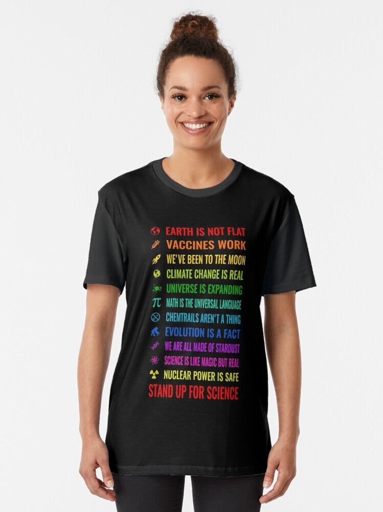 Graphic t-shirt with text "Earth is not flat! Vaccines work! We've been to the moon! Chemtrails aren't a thing! Climate change is real! Stand up for science! Universe is expanding! Nuclear power is safe!" - Women