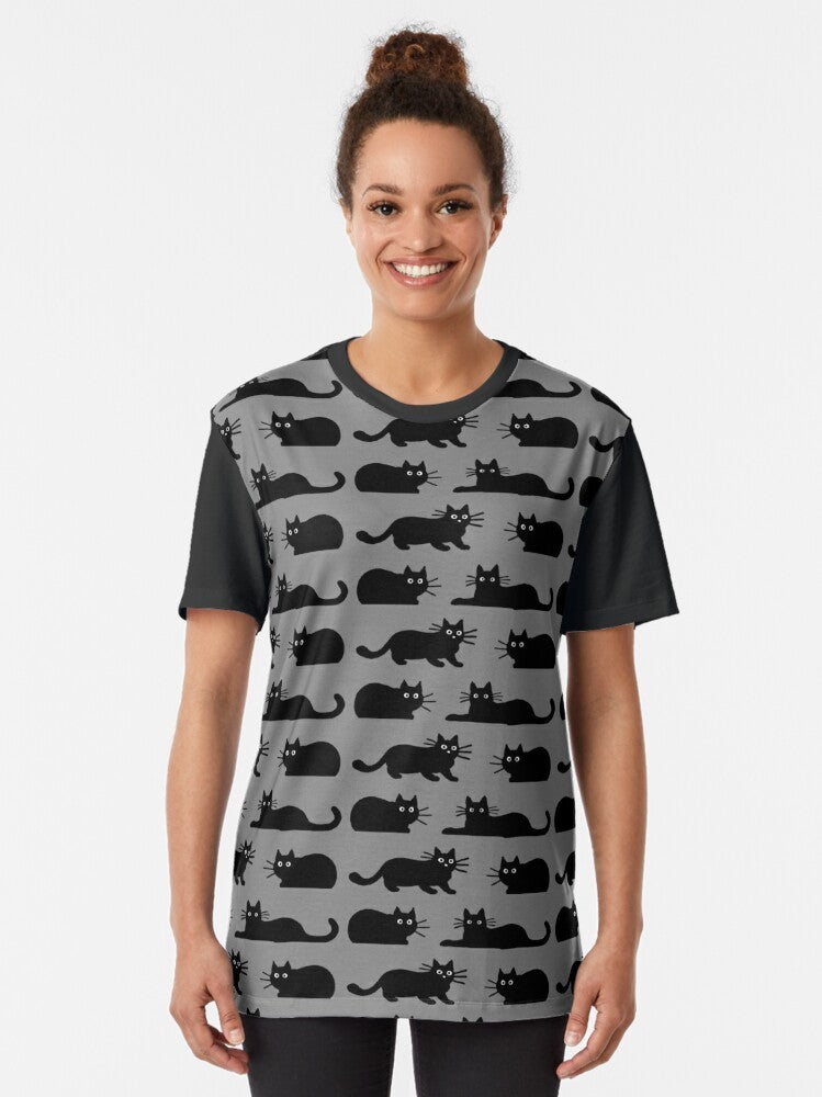 A black cat graphic t-shirt featuring a playful feline design - Women