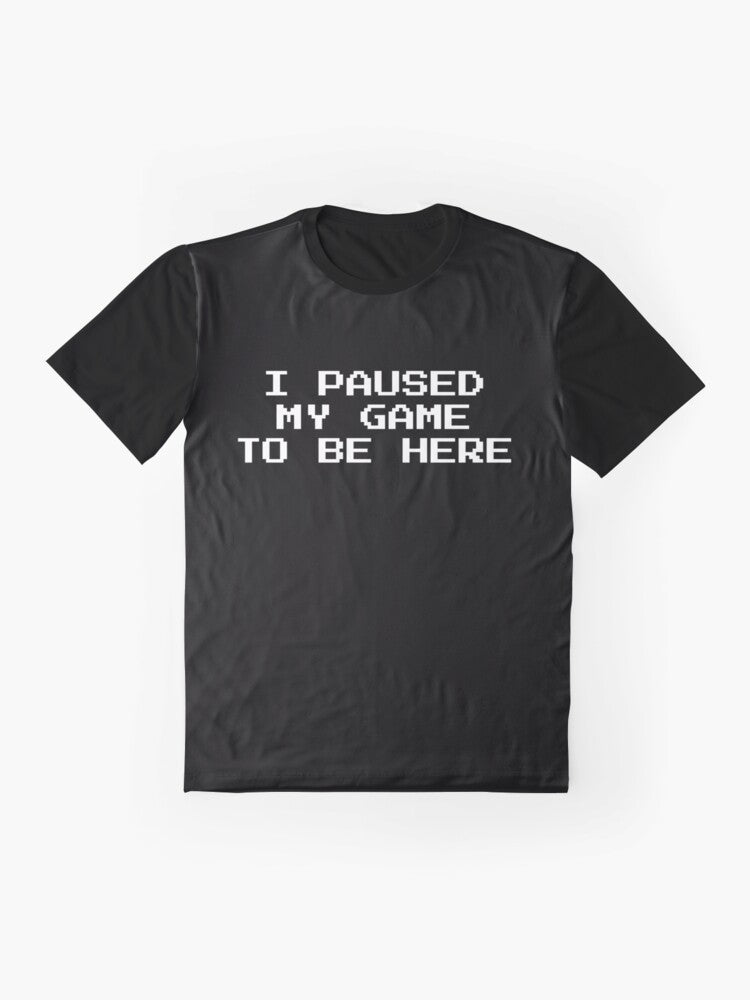 Graphic t-shirt with text "I Paused My Game to Be Here" for gamers and geeks. - Flat lay