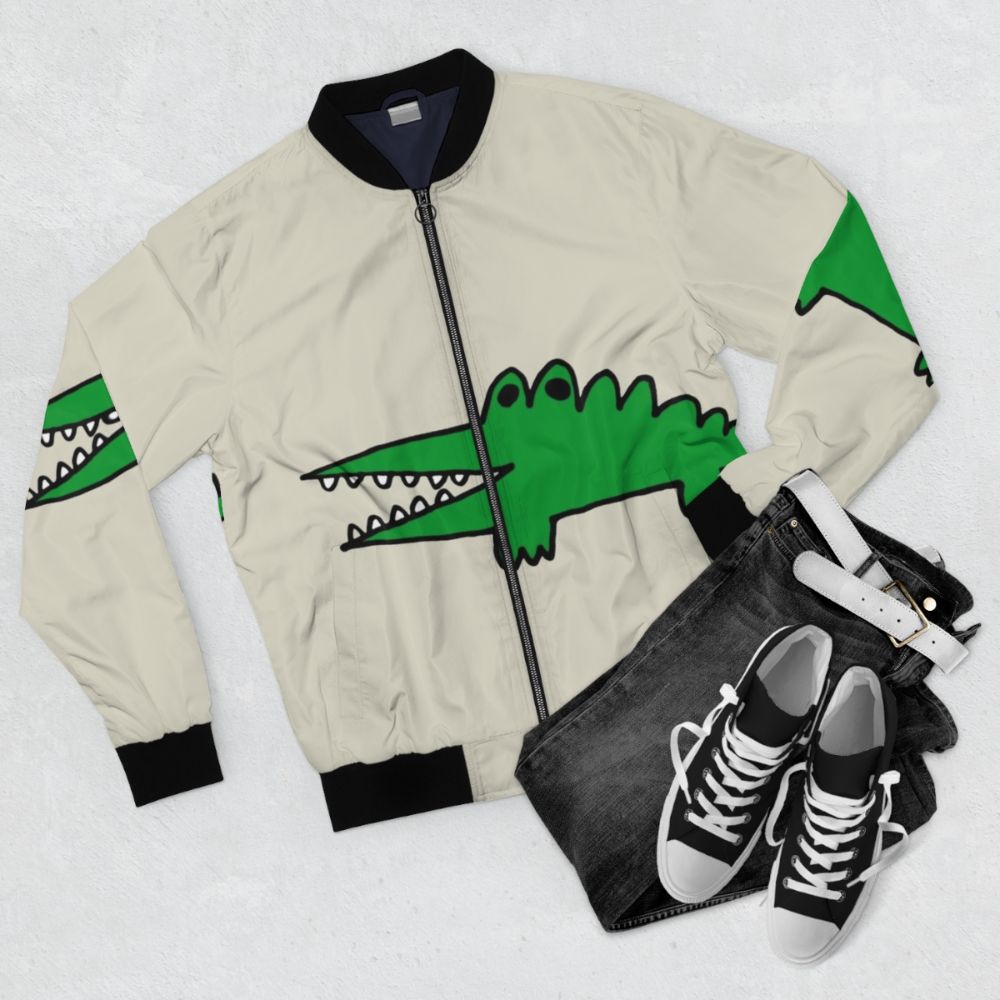 Cute alligator bomber jacket with a cartoon graphic design - Flat lay