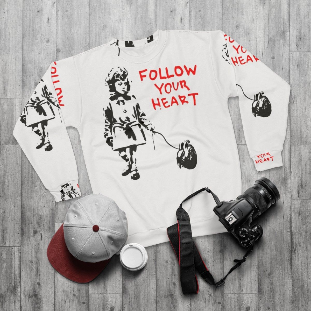 Banksy "Follow Your Heart" Sweatshirt featuring iconic street art design - flat lay