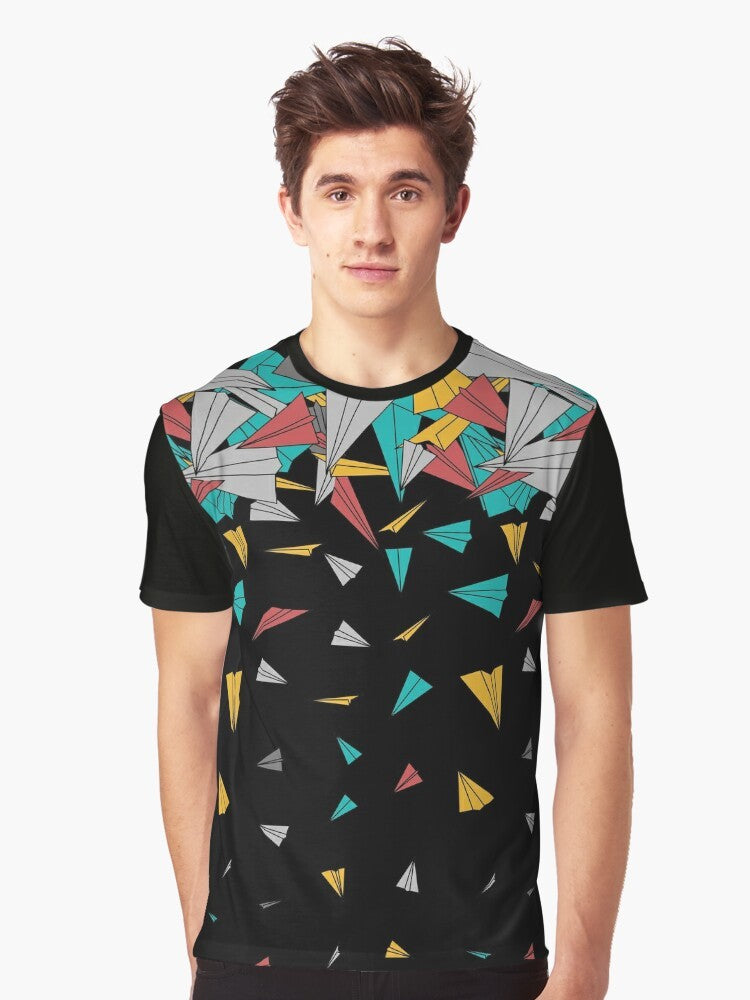 A colorful, abstract graphic t-shirt featuring a design of paper planes floating on a geometric pattern. - Men