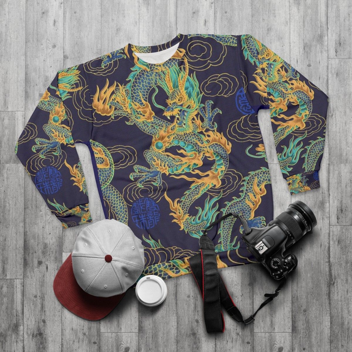 Gilded dragon design on a blue sweatshirt - flat lay