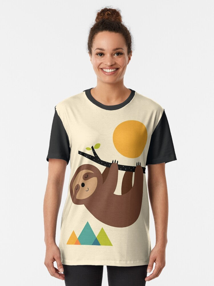 A graphic t-shirt design featuring a relaxed sloth in a natural landscape - Women