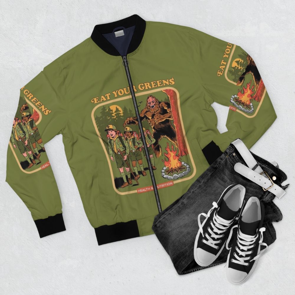 Retro 'Eat Your Greens' bomber jacket with bigfoot, monster, and occult-inspired design - Flat lay