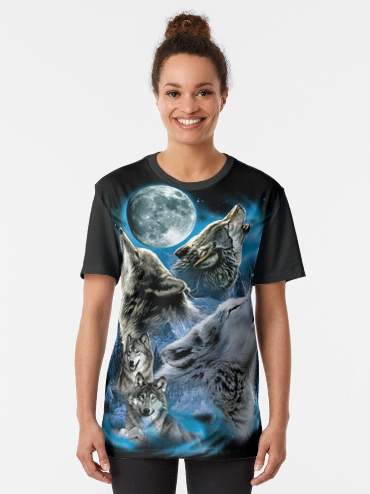 A graphic t-shirt featuring a howling wolf family under a full moon in the wilderness. - Women