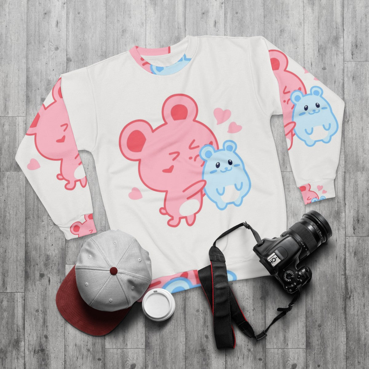 Two adorable hamsters printed on a pink and blue pastel sweatshirt - flat lay