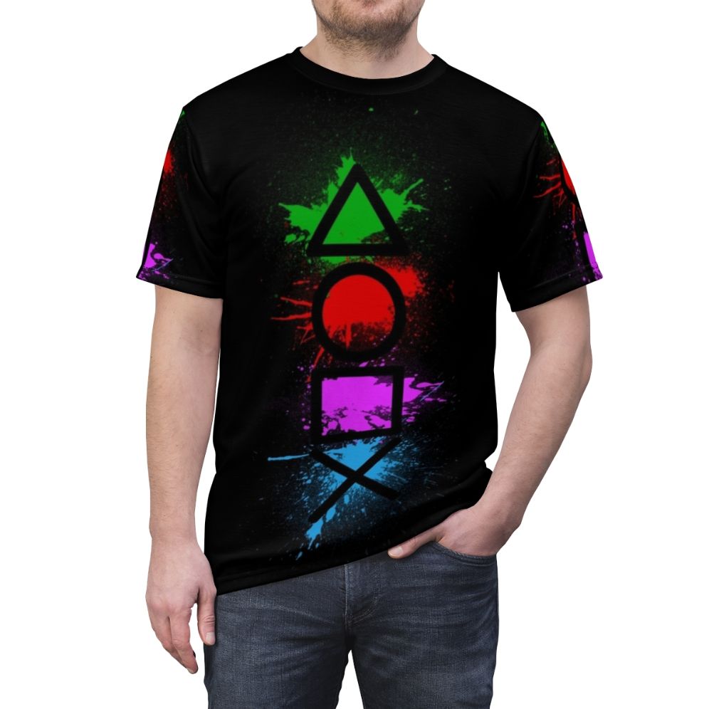 Graphic t-shirt featuring a splatter design of classic video game controller buttons - men front