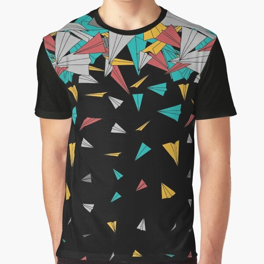 A colorful, abstract graphic t-shirt featuring a design of paper planes floating on a geometric pattern.