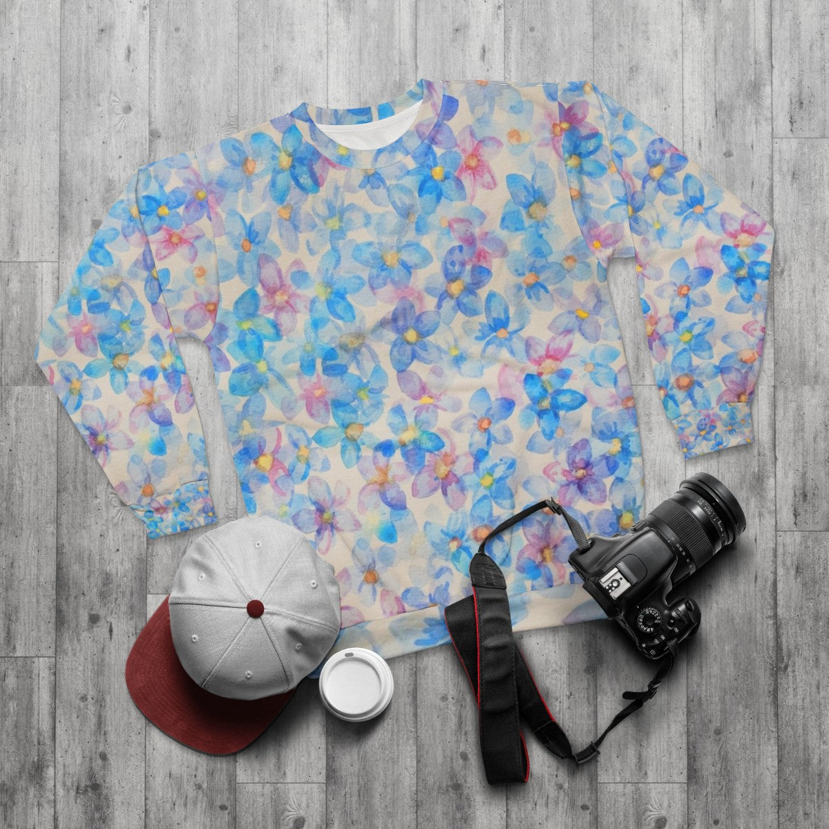 Blue watercolor flower buds painting on sweatshirt - flat lay