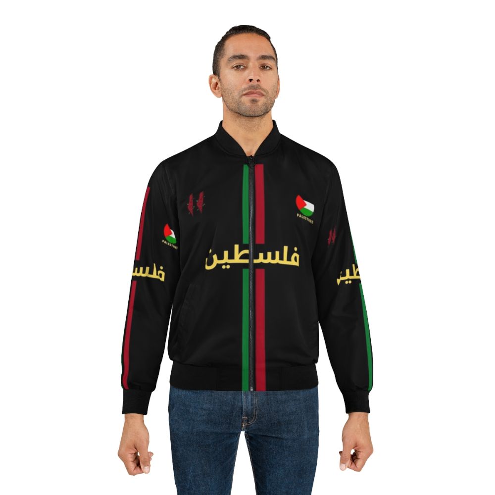 A black bomber jacket featuring a Free Palestine football design with Arabic calligraphy. - Lifestyle