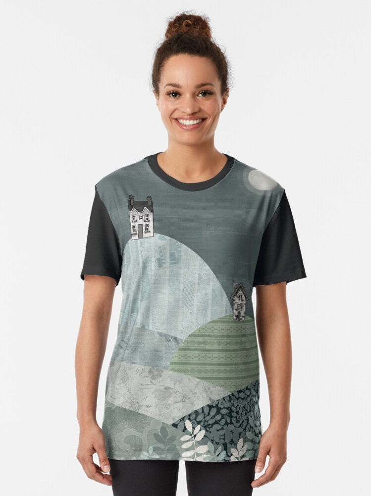 Cozy winter landscape graphic t-shirt featuring a village nestled in hills under a starry night sky - Women