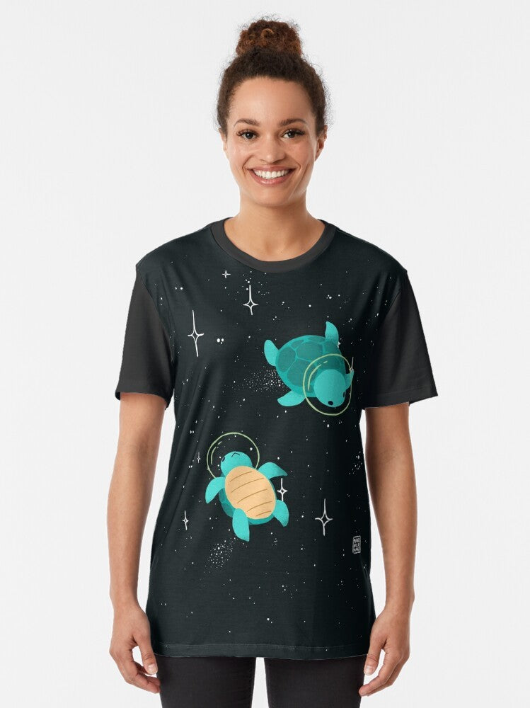 Adorable space turtle graphic design on a green t-shirt with stars and cosmic elements. - Women