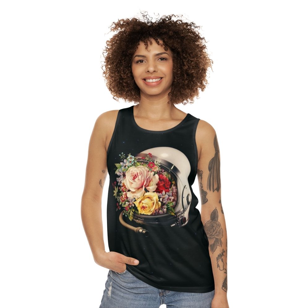 An astronaut in a space suit surrounded by flowers and stars on a cosmic, surreal tank top - women