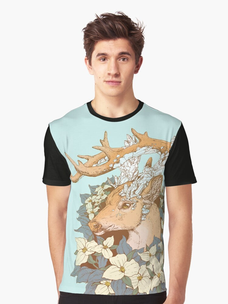 A graphic t-shirt featuring a non-typical blue quartz buck design with antlers and trillium flowers in a nature-inspired illustration. - Men