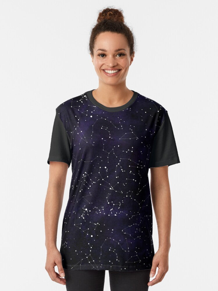 A graphic t-shirt featuring the constellations of the northern hemisphere against a starry night sky background. - Women