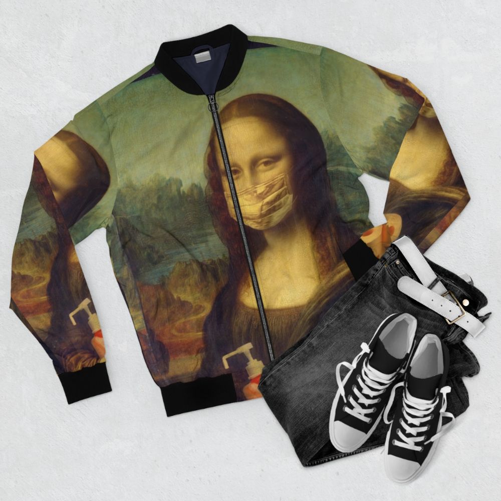 A bomber jacket featuring a comic-style illustration of the Mona Lisa with COVID-19 imagery. - Flat lay