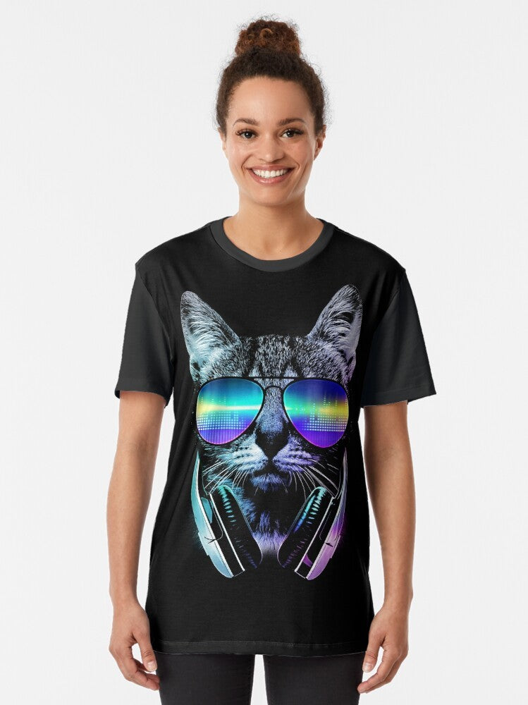 A stylish graphic t-shirt featuring a cool cat wearing headphones and surrounded by a music-inspired urban cityscape design. - Women