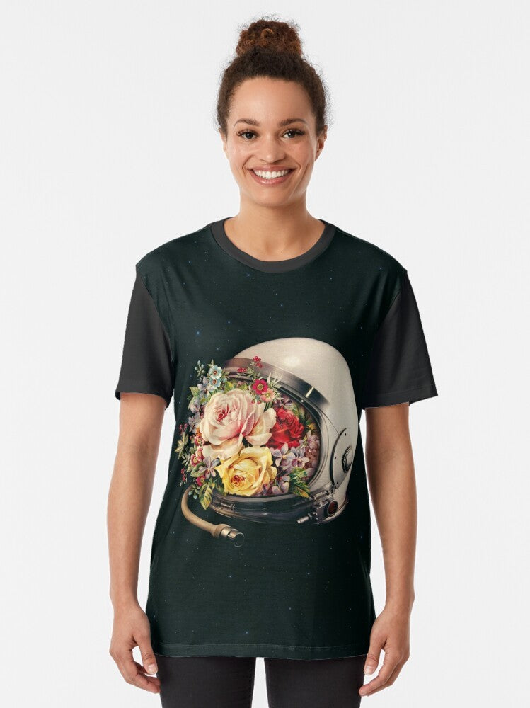 A surreal graphic t-shirt featuring an astronaut in space surrounded by flowers and stars - Women