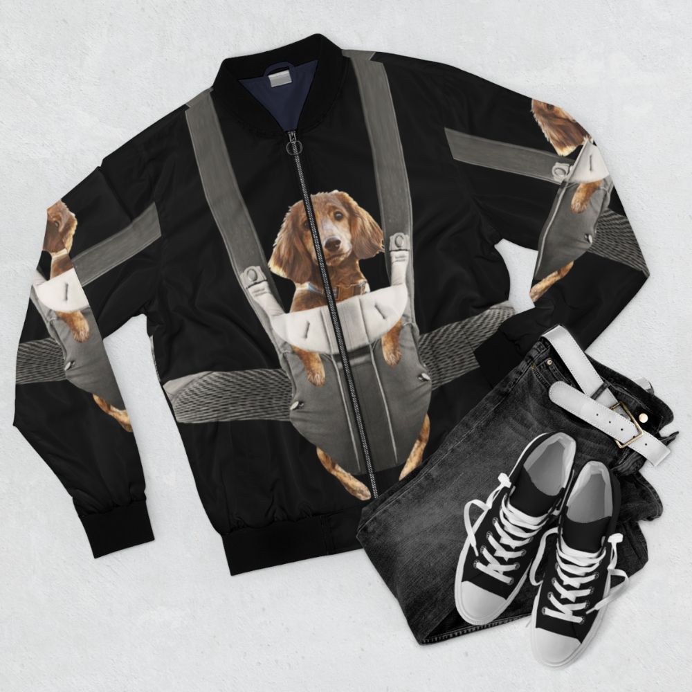 Adorable dachshund wearing a bomber jacket and sitting in a baby carrier, creating a funny and cute scene. - Flat lay