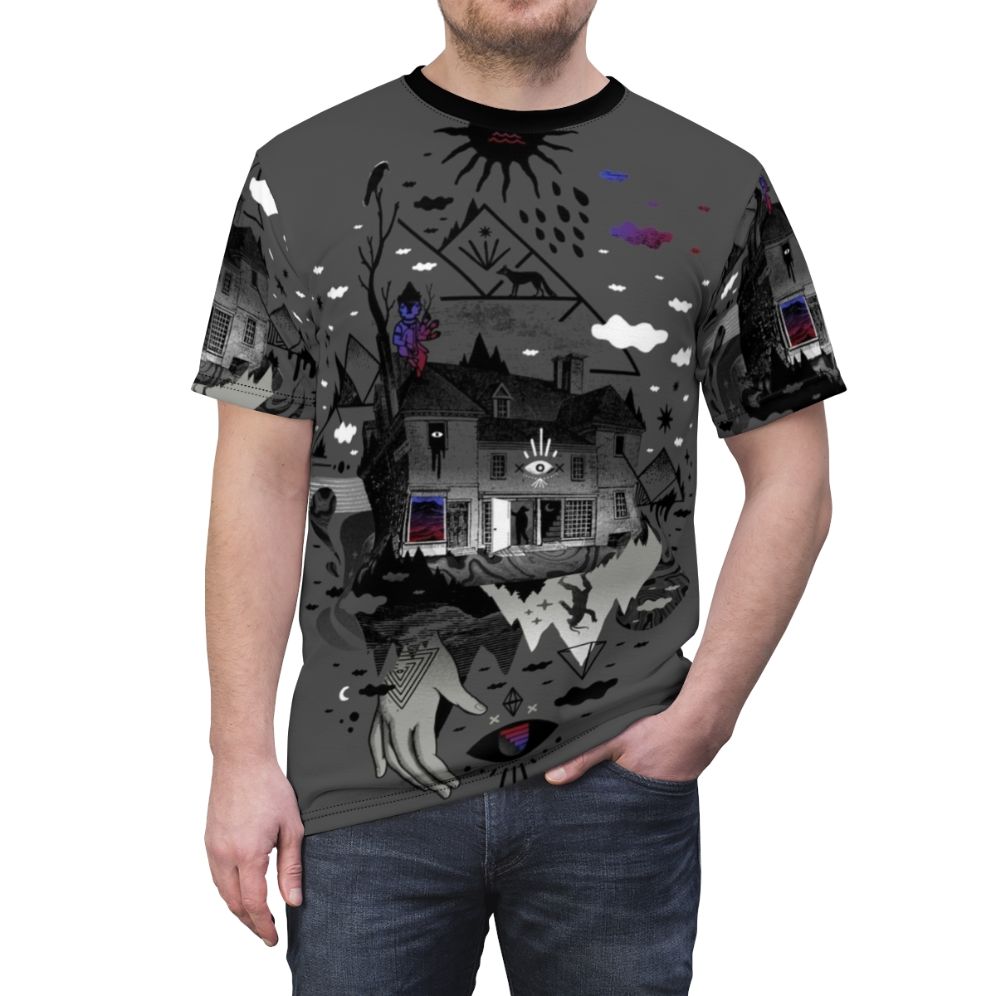 A surreal and abstract t-shirt design featuring a collage of dark mountain shapes, stars, moon, and other symbolic elements. - men front