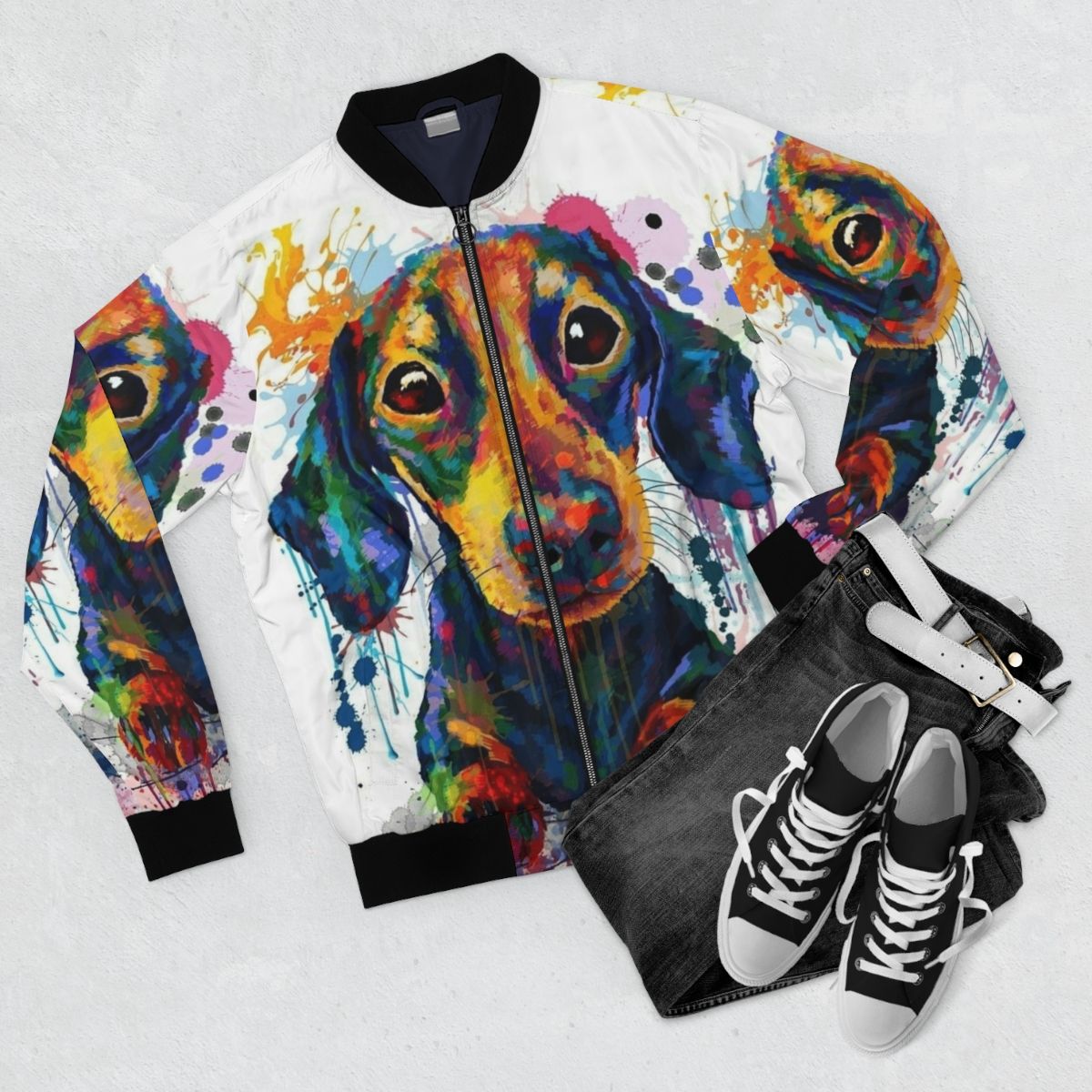 A black bomber jacket with a cute dachshund dog art design. - Flat lay