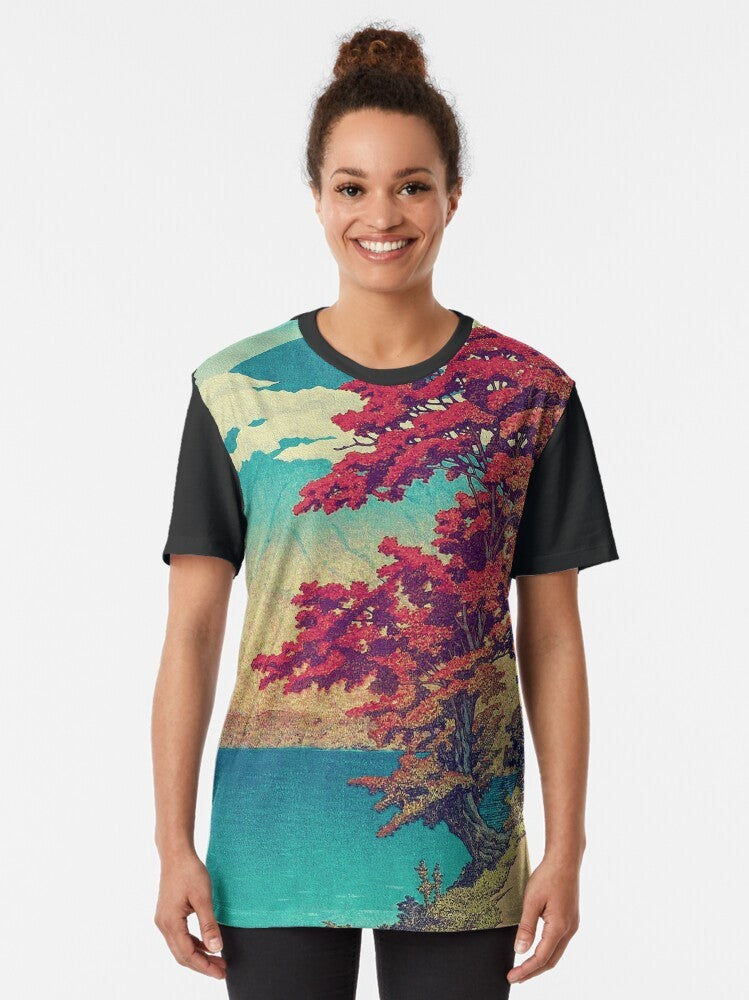 Ukiyo-e inspired landscape graphic t-shirt featuring a mountain, lake, and clouds in shades of red, blue, and summer/autumn tones - Women