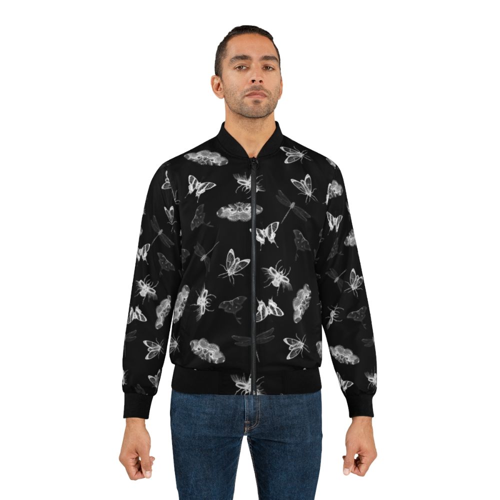 Bomber jacket with a black and white pattern of various bugs, insects, and entomology elements for a creepy, nightmare-inducing design. - Lifestyle