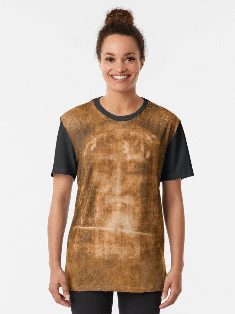 T-shirt featuring the Holy Face of Jesus and a crucifix, representing the passion and resurrection of Christ. - Women