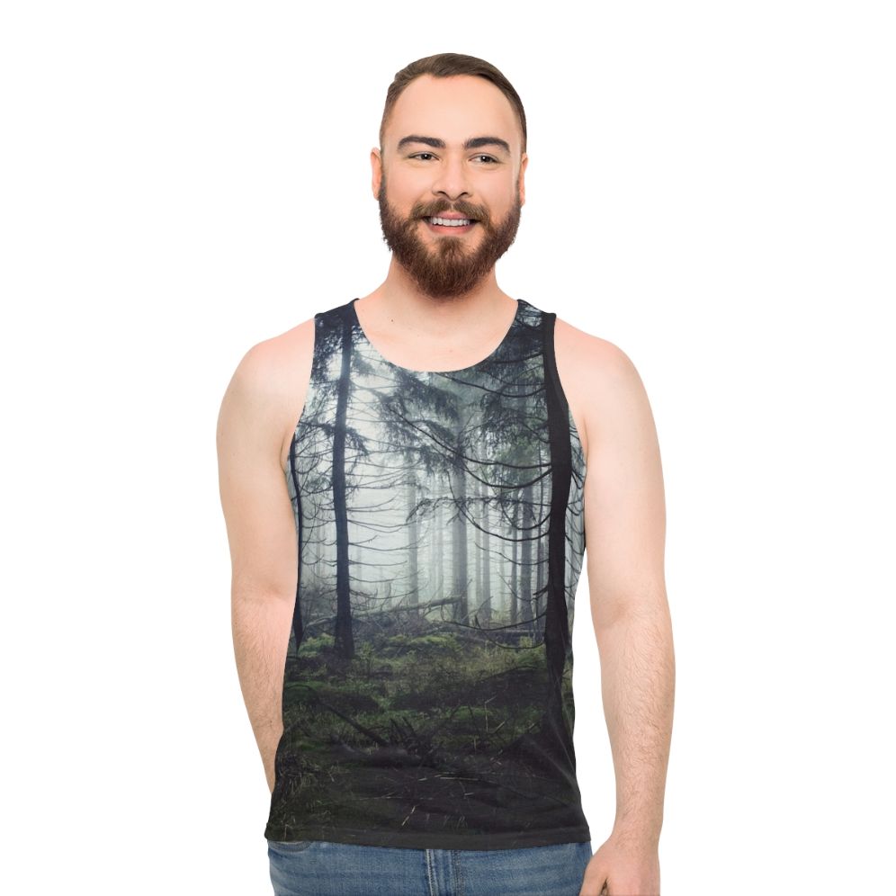 Person wearing unisex nature tank top standing in a forest - men